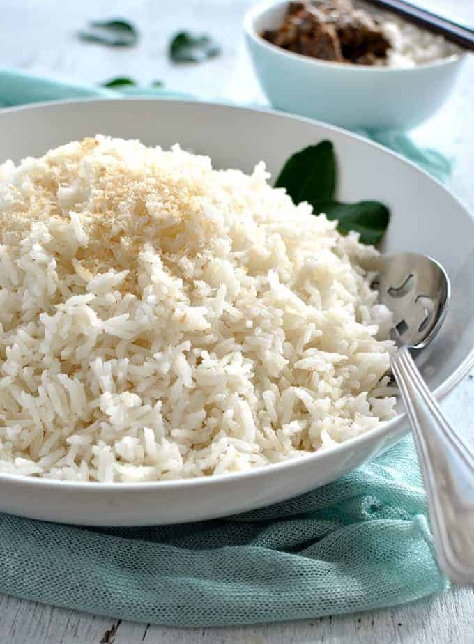 Fluffy coconut rice in a white bowl, ready to be served.